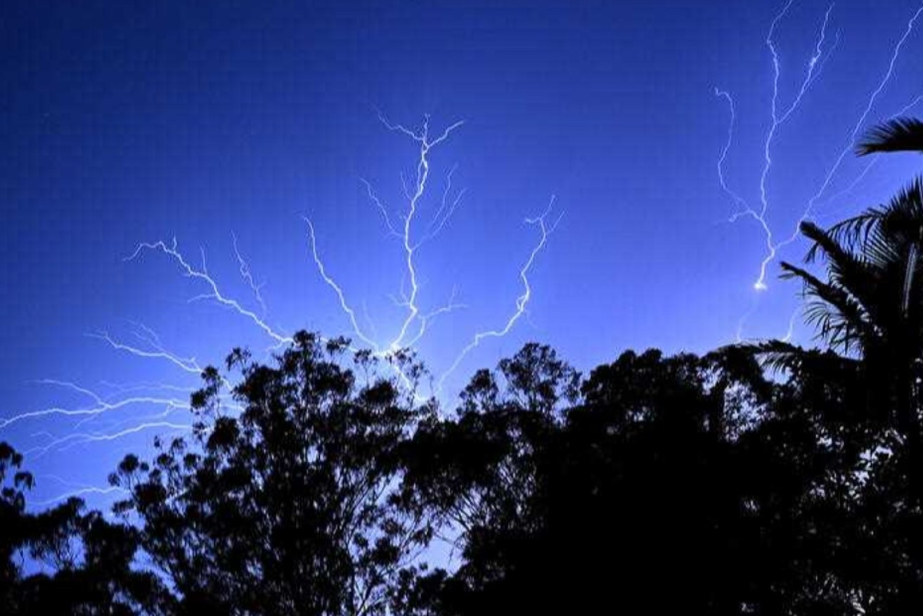 An electrical storm is seen at Reedy Creek on the Gold Coast Monday. Photo: AAP/Dave Hunt
