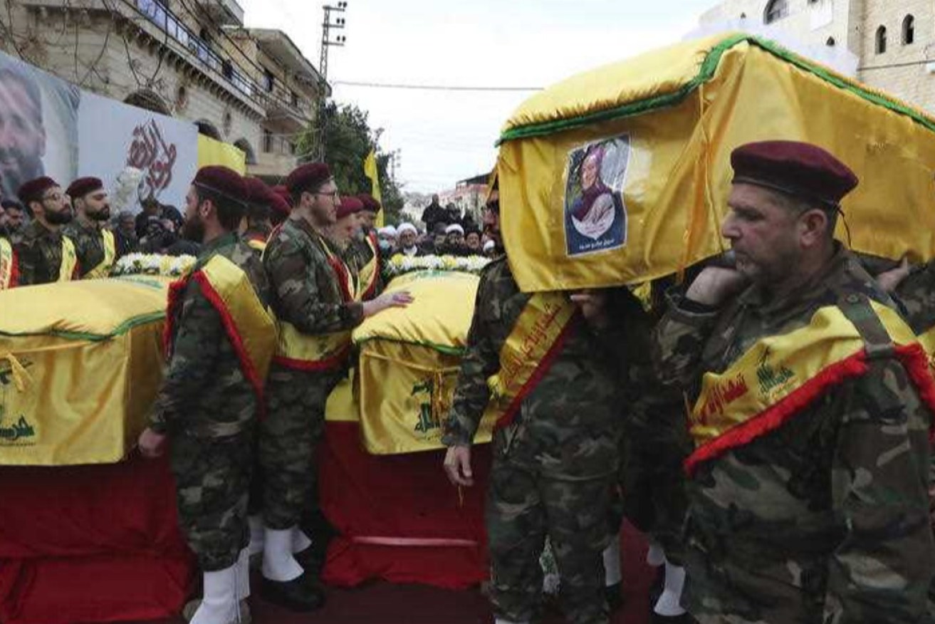 Hezbollah fighters carry the coffin of Shorouk Hammoud the wife of Ibrahim Bazzi, a couple who were killed with another Hezbollah fighter inside a house that was hit by an Israeli airstrike Tuesday night. Photo: AAP