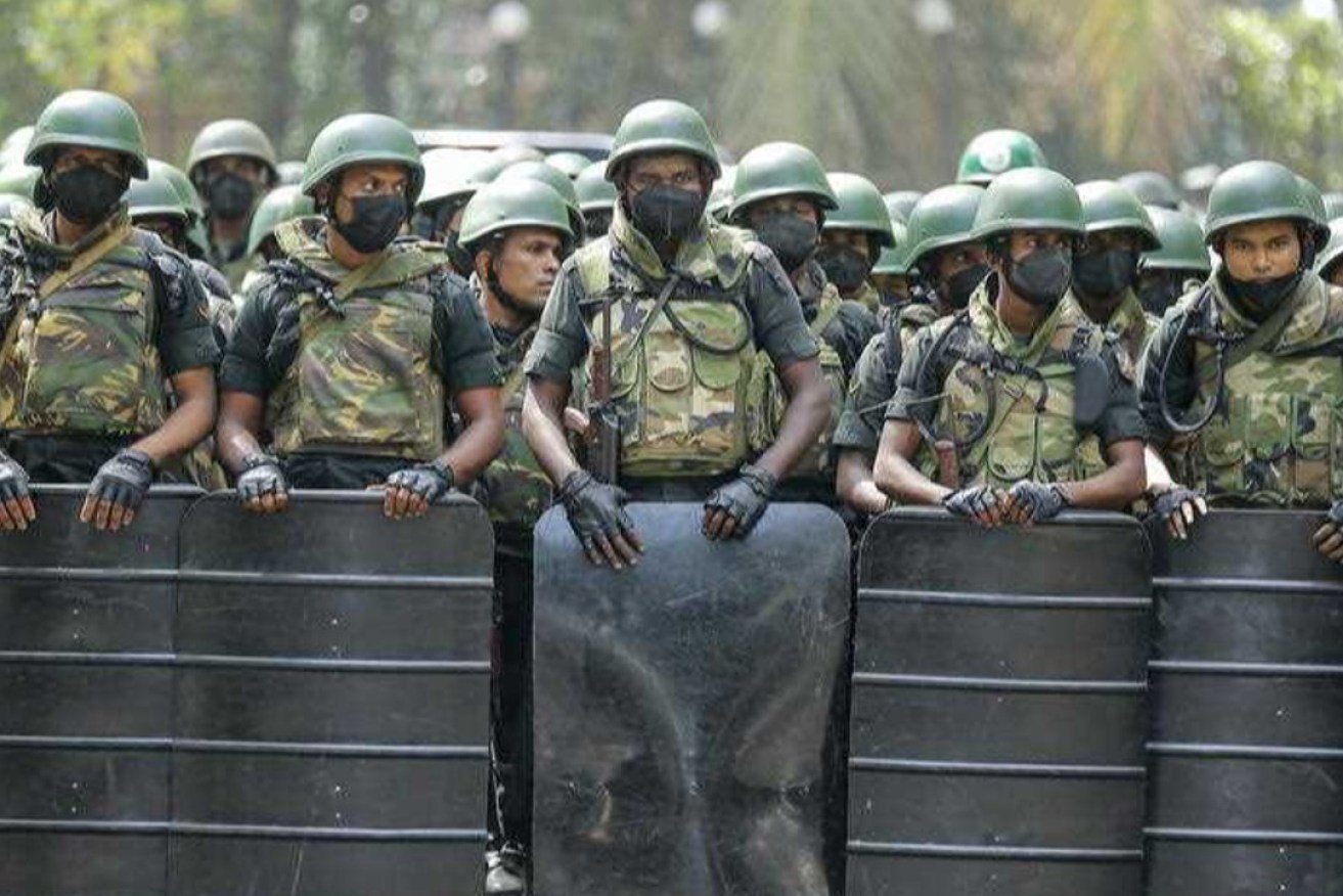 Armed soldiers in Sri Lanka block a road during protests over tax reforms in January 2023. Tensions have not eased across the nation and it's a flash point to watch in 2024. Photo: EPA/Chamalia Karunarathne