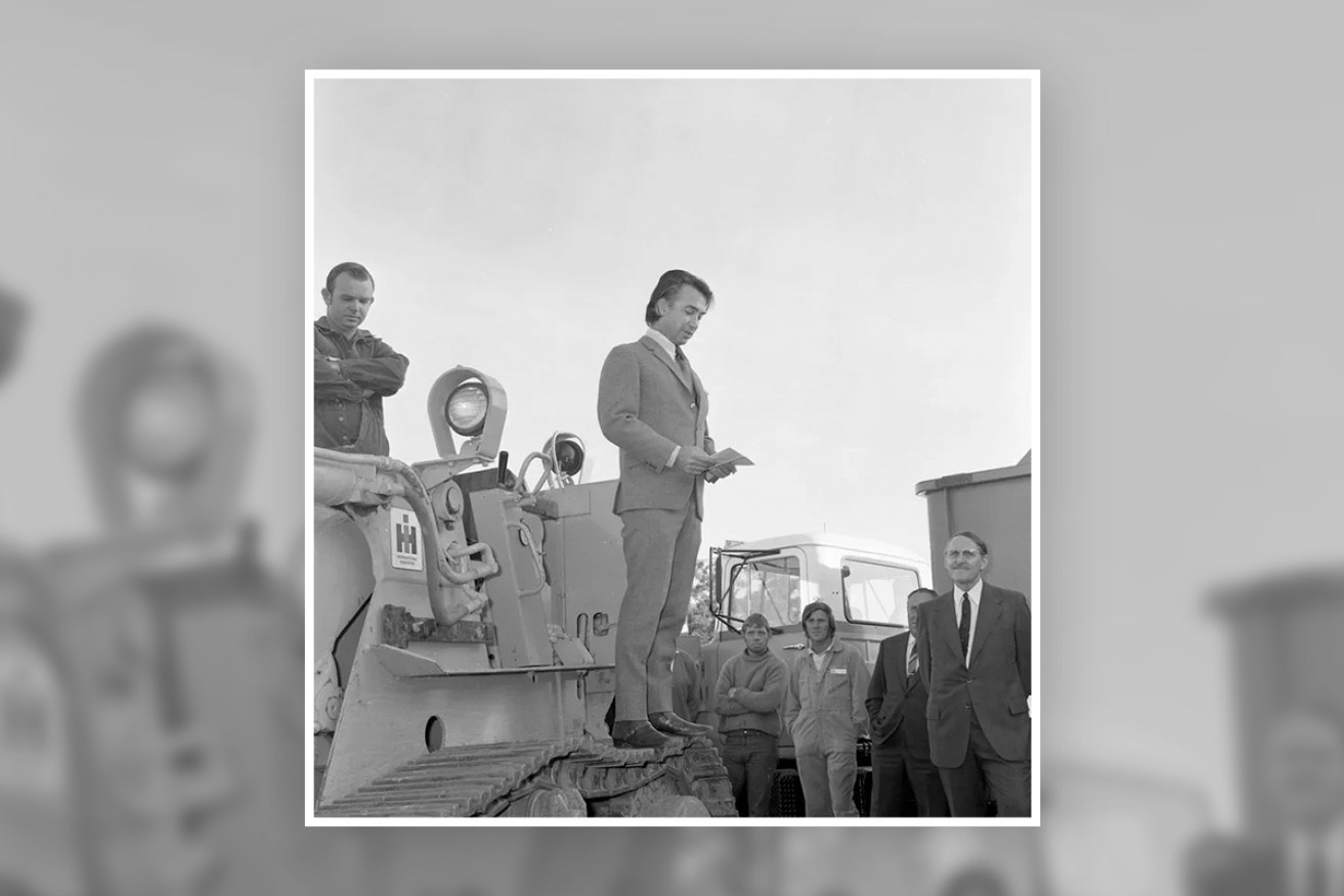 Towering impact: Don Dunstan standing on a bulldozer at the initiation of work ceremony for the construction of Flinders Medical Centre in 1972. Photo courtesy Dunstan Collection