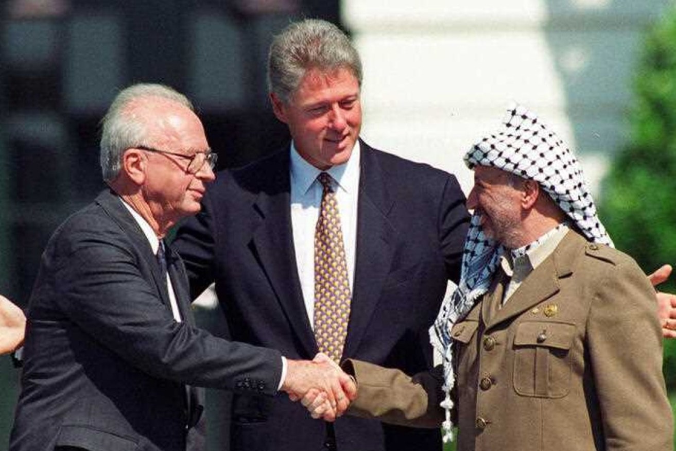 Israeli Prime Minister Yitzhak Rabin, left, and Palestinian leader Yasser Arafat shake hands marking the signing of the peace accord between Israel and the Palestinians, in Washington, Sept. 13, 1993. Photo: AP/Ron Edmonds