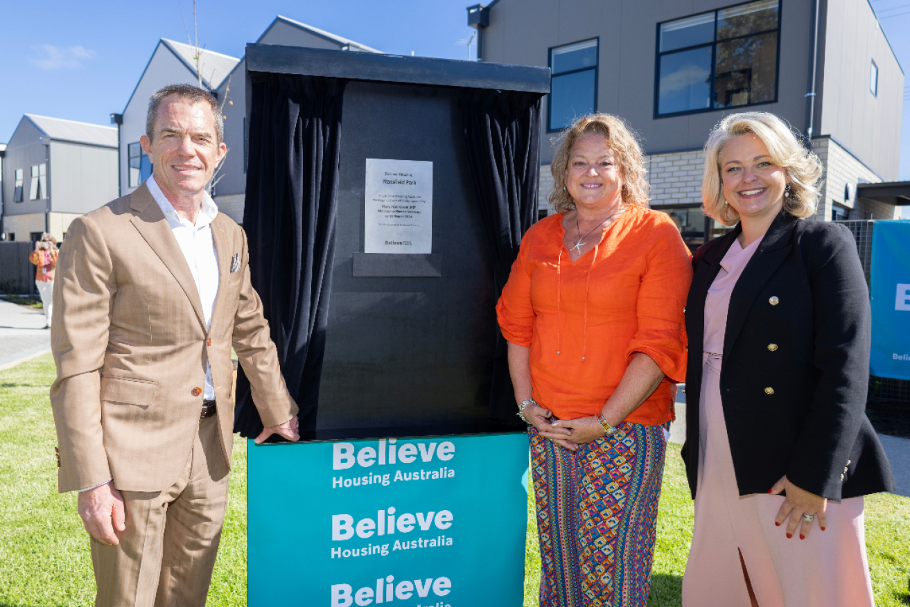Believe Housing Australia Board Chair Tim Sarah, Human Services Minister Nat Cook and Believe Housing Australia Executive General Manager Stacey Northover unveiling a plaque to launch the Believe Housing Mansfield Park affordable rental housing development. Photo: Believe Housing.
