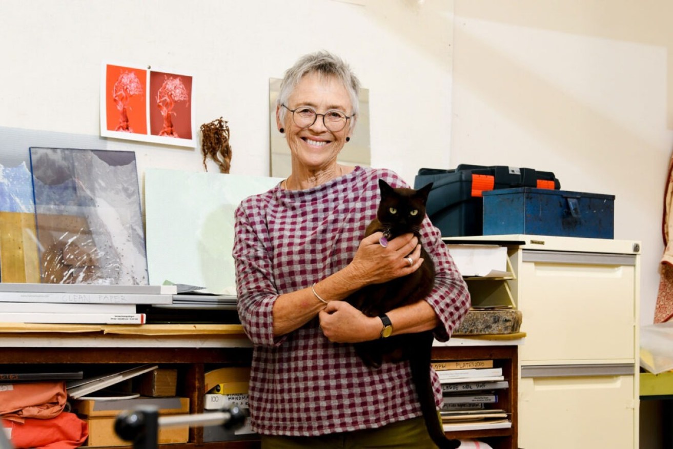 Olga Sankey with one of her cats in the studio at her Underdale home. Photo: Jack Fenby / InReview