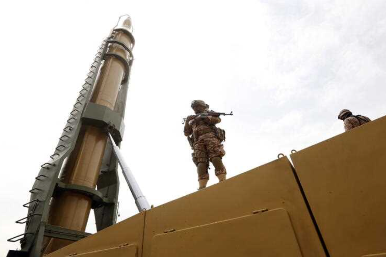 An Iranian soldier stands next to an Shahab-3 missile during a rally in Tehran, Iran, 29 April 2022. Photo: EPA