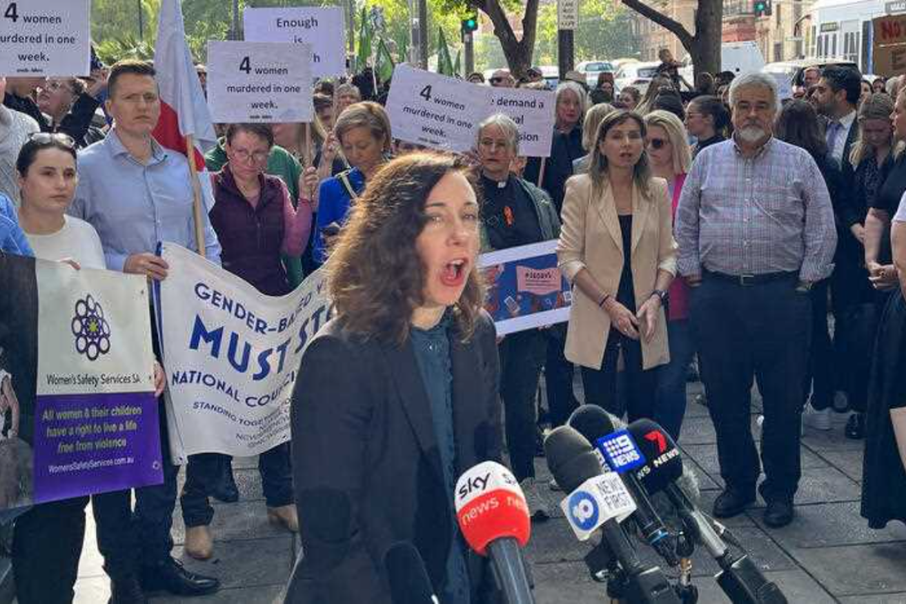 Embolden SA managing director Mary Leaker calls for a royal commission into domestic violence during a rally outside Parliament House on Friday.