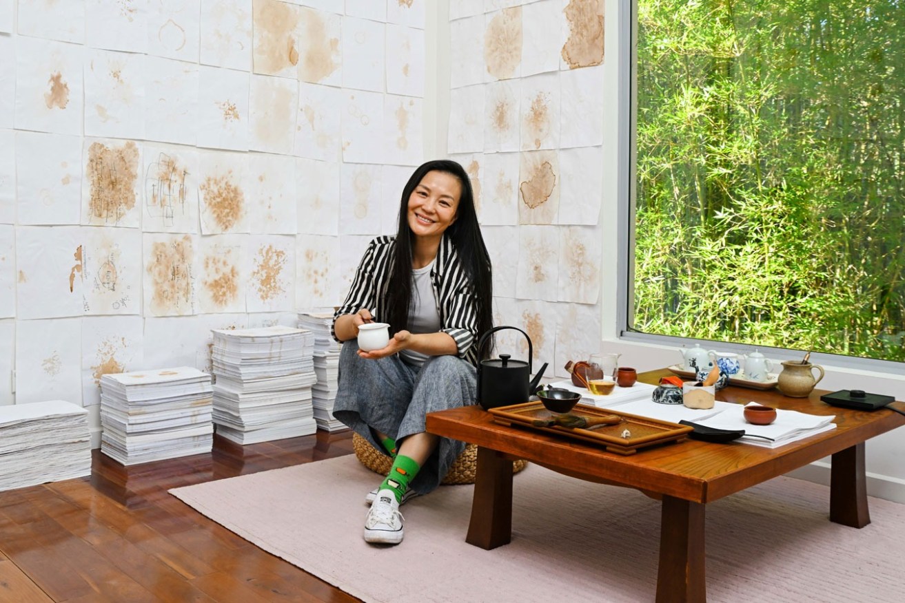 The walls of Jingwei Bu's tearoom are decorated with tea-stained pieces of paper collected during a residency at Nexus Arts. Photo: Jack Fenby / InReview
