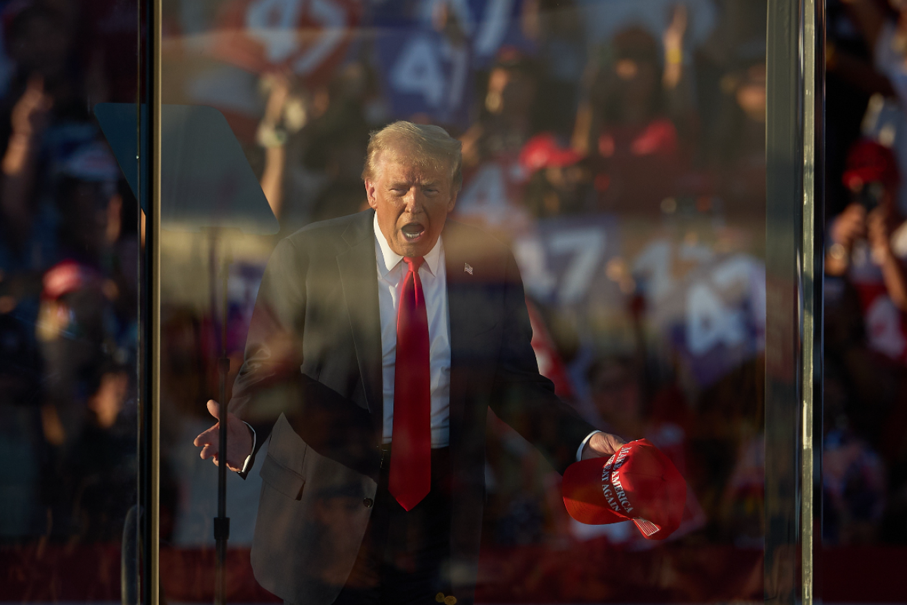 Donald Trump at an election rally in Coachella, California. A man was arrested with guns and ammunition at a security checkpoint. Photo: AAP